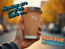 a person holding a cup of coffee with the words monday let 's do this on the bottom