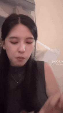 a close up of a woman 's face with bigo live in the upper right corner