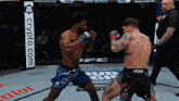 two men are fighting in a boxing ring with a crypto.com banner in the background
