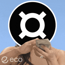 a woman is holding a stack of money in front of a black circle with a white circle in the middle