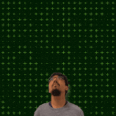 a man stands in front of a green background with the number 3 + 1