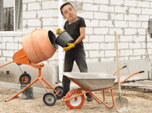 a man is pouring cement into a mixer while holding a bucket