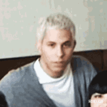 a blurry picture of a man 's face with rbd.gif written on the bottom right