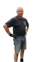 a man with his hands on his hips is wearing a black shirt