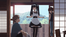 a girl in a maid outfit stands in front of a boy and a woman