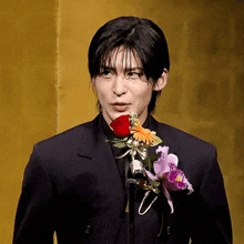a man in a suit has a flower on his jacket
