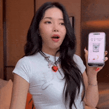 a woman holding a cell phone that says yogurt