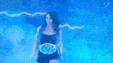 a woman is standing in a cloud of blue smoke .