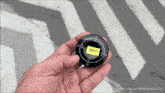 a person is holding a small device that says ad15