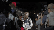 a girl holding a book that says " family "