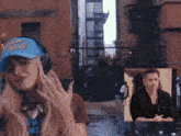 a woman wearing headphones and a hat that says ' vision doll '
