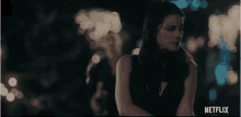 a woman in a black dress is shown in a netflix advertisement
