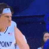a basketball player wearing a headband and a white jersey with the word point on it