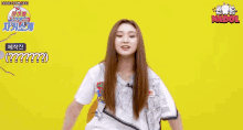 a girl with long hair is sitting in a chair with her arms outstretched and a white shirt on .