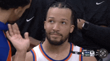 a basketball player with nyk on his jersey