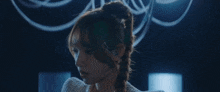 a close up of a woman with braided hair
