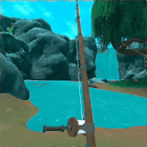 a fishing rod is sitting on a beach near a waterfall