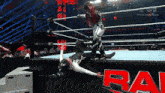 a wrestling match is being shown on a tv screen with the word raw on it