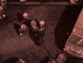 an aerial view of a group of soldiers standing around a car