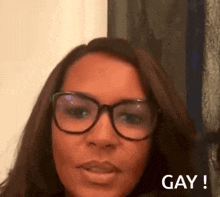 a woman wearing glasses says gay in a blurred image