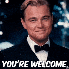 a man in a tuxedo and bow tie is smiling with the words you 're welcome below him