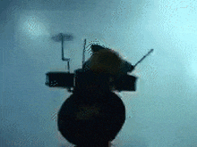 a silhouette of a person playing a piano in a dark room with a blue background