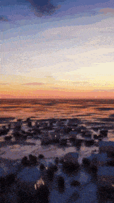 a blurry picture of a sunset over the ocean