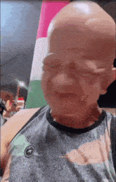 a man with a bald head is wearing a shirt that says abercrombie & fitch on it