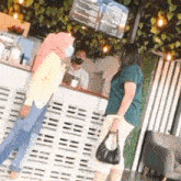 three women are standing in front of a counter in a restaurant .