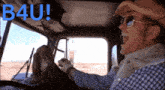 a man driving a truck with a dog behind him and the words b4u written on the roof