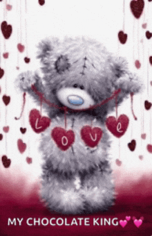 a teddy bear is holding a string of hearts with the words " my chocolate king " on the bottom