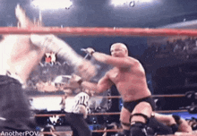 two wrestlers are fighting in a wrestling ring .
