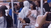 a group of people are standing in a line and one of them is wearing a barbie bosti costume