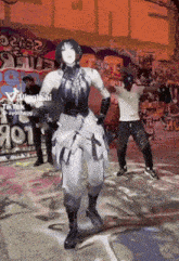 a girl is dancing in front of a wall with graffiti on it that says ' tiktok ' on it