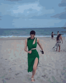 a woman in a green dress is giving a thumbs up