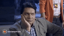 a man with his hand on his face is on a screen that says www.sonyliv.com