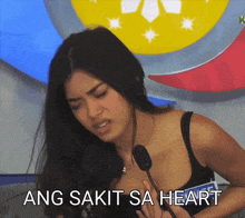 a woman holding her chest with the words ang sakit sa heart written below her