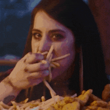 a woman is eating french fries in a restaurant