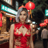 a woman in a red dress stands in front of a sign that says ' a ' on it