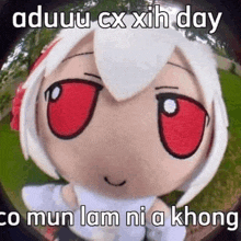 a stuffed animal with red eyes and white hair is looking at the camera with a caption .