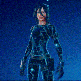 a woman is standing in front of a blue background holding a glowing object .