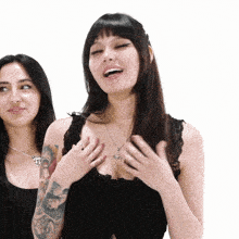 a woman with a tattoo on her arm is smiling