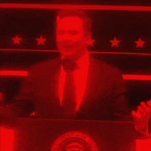 a man in a suit and tie stands at a podium with the seal of the president of the united states