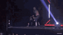 a man in a wrestling ring with the word subscribe on the bottom right