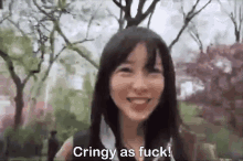 a woman is smiling in a park with the words `` cringy as fuck '' written next to her .
