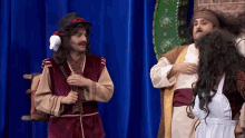 a man in a costume is standing next to a woman