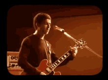 Playing Guitar Oasis GIF - Playing Guitar Oasis Stop Crying Your Heart Out GIFs