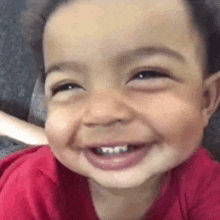 a close up of a baby 's face smiling .