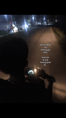 a person is riding a motorcycle at night and the words love em are on the back