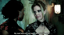two women are standing next to each other and one of them is saying my mad face and my happy face are the same .